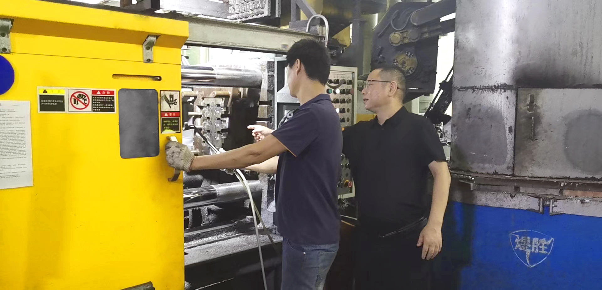 manufacturing boss helping worker