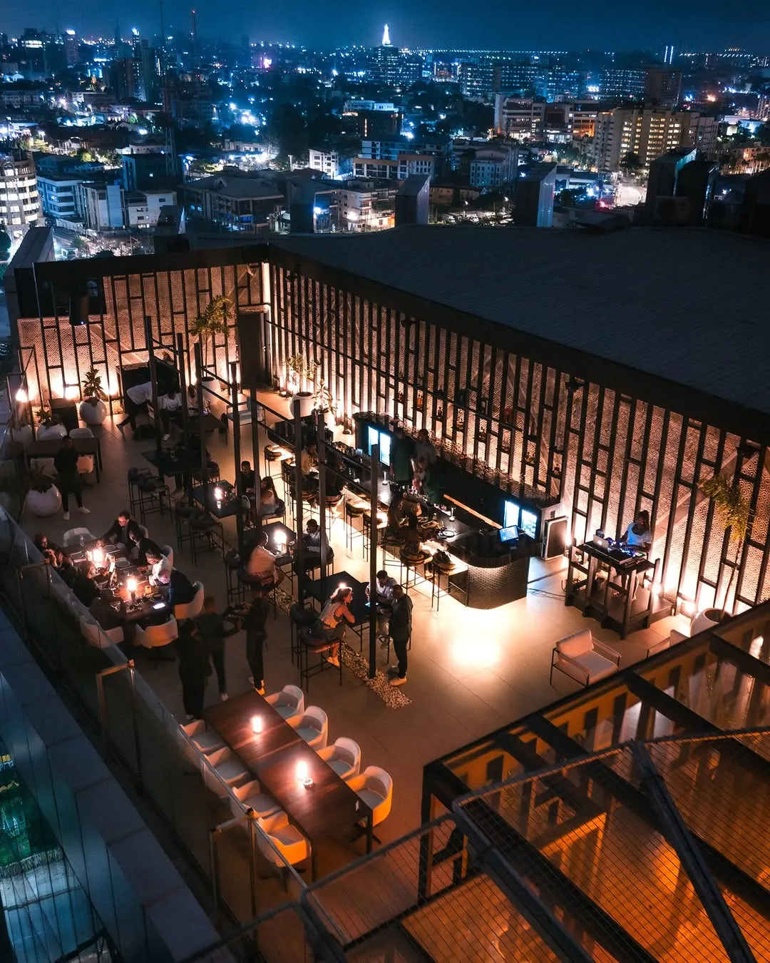 Elegant rooftop dining at Sora Lagos with panoramic city and ocean views, ideal for a romantic dinner in Lagos