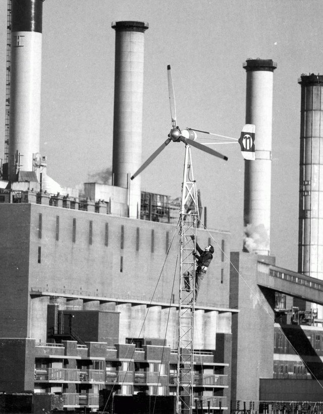 The windmill, with someone servicing it, in the East Village - flexfarmd building renewable energy microgrids