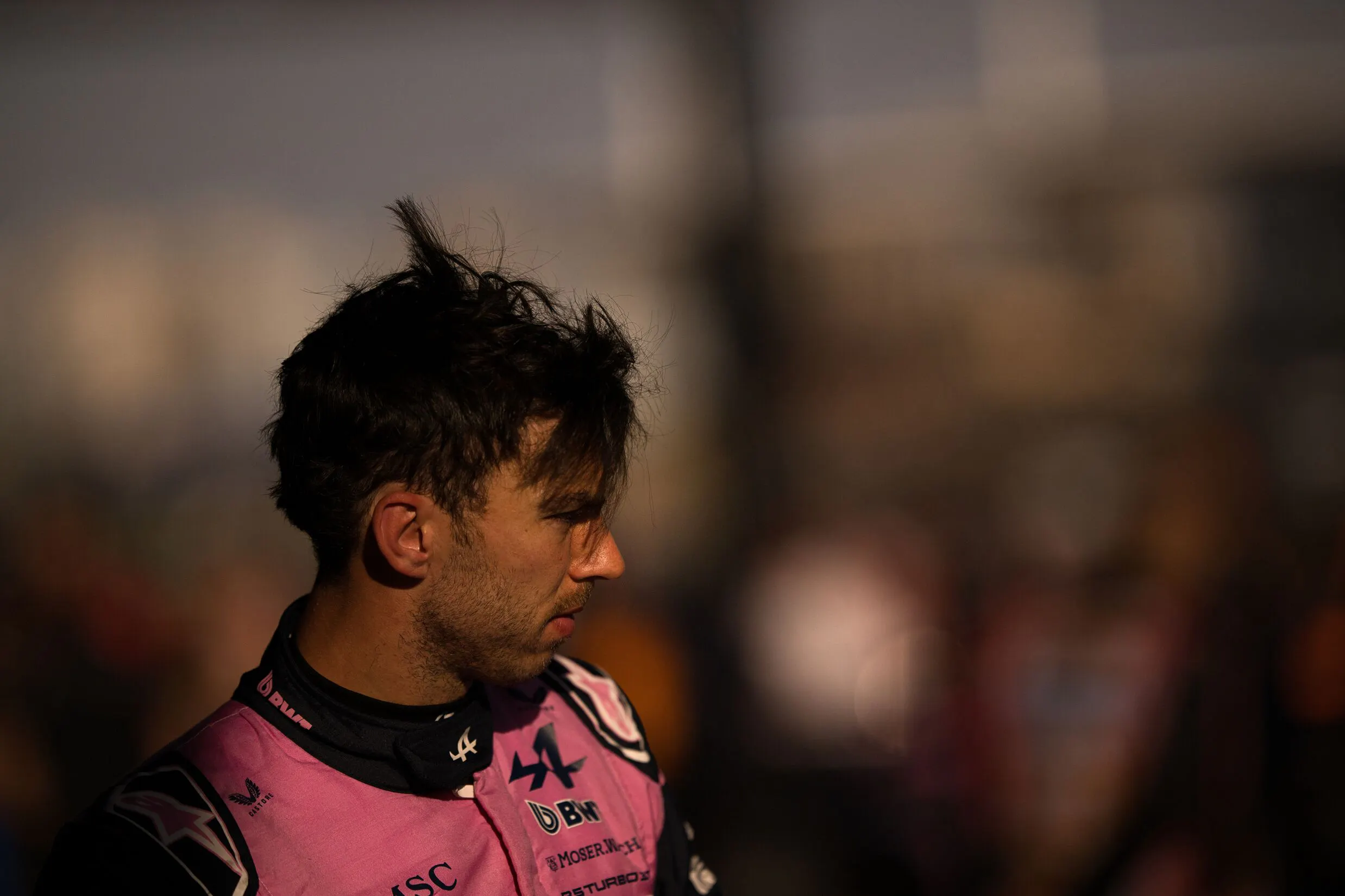 F1 race driver in pink and black uniform