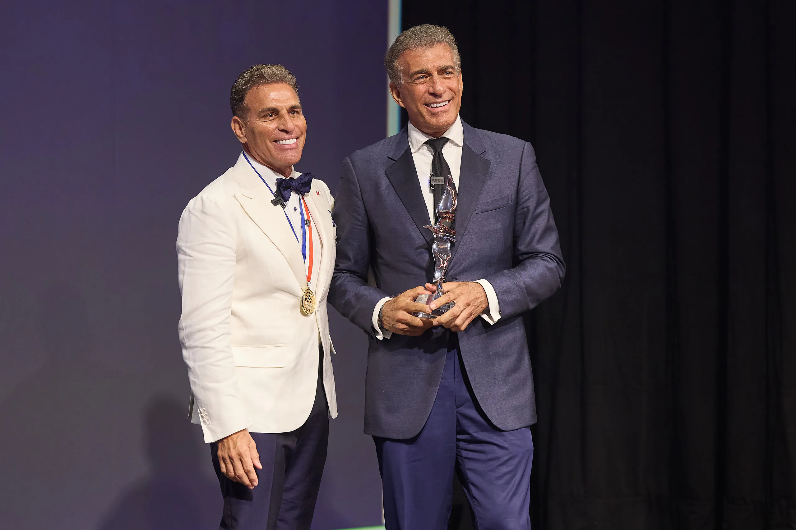 Kenn Ricci with Steve Varsano on stage shaking hands