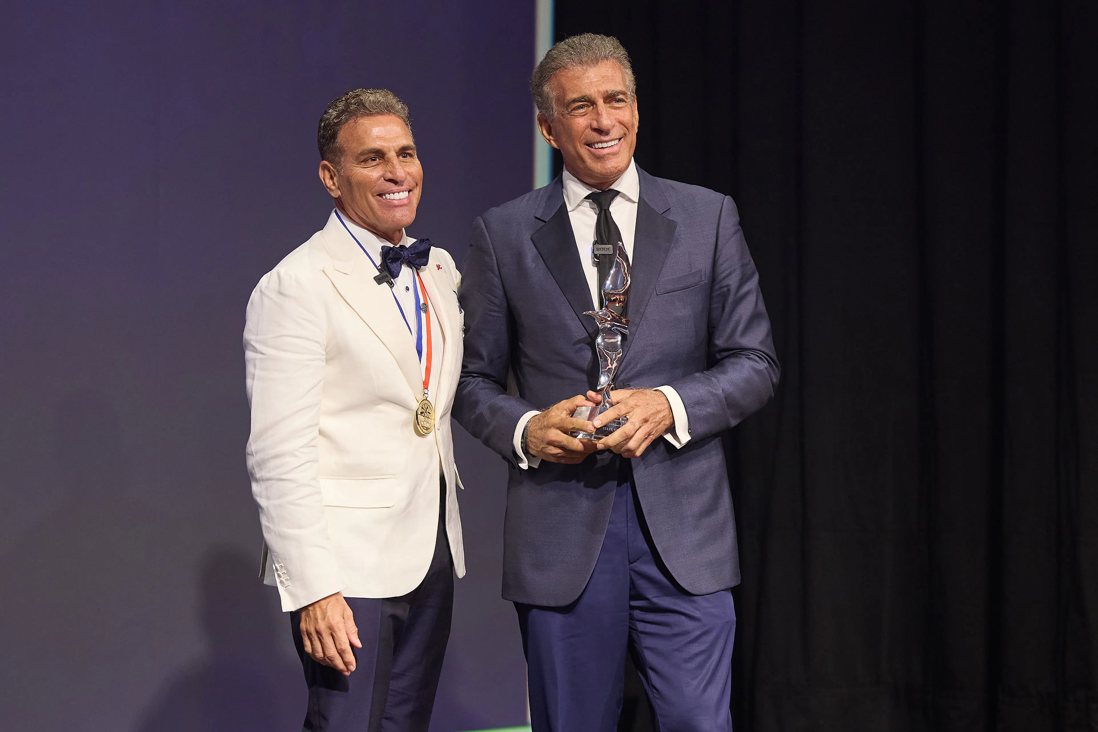 Kenn Ricci with Steve Varsano on stage shaking hands