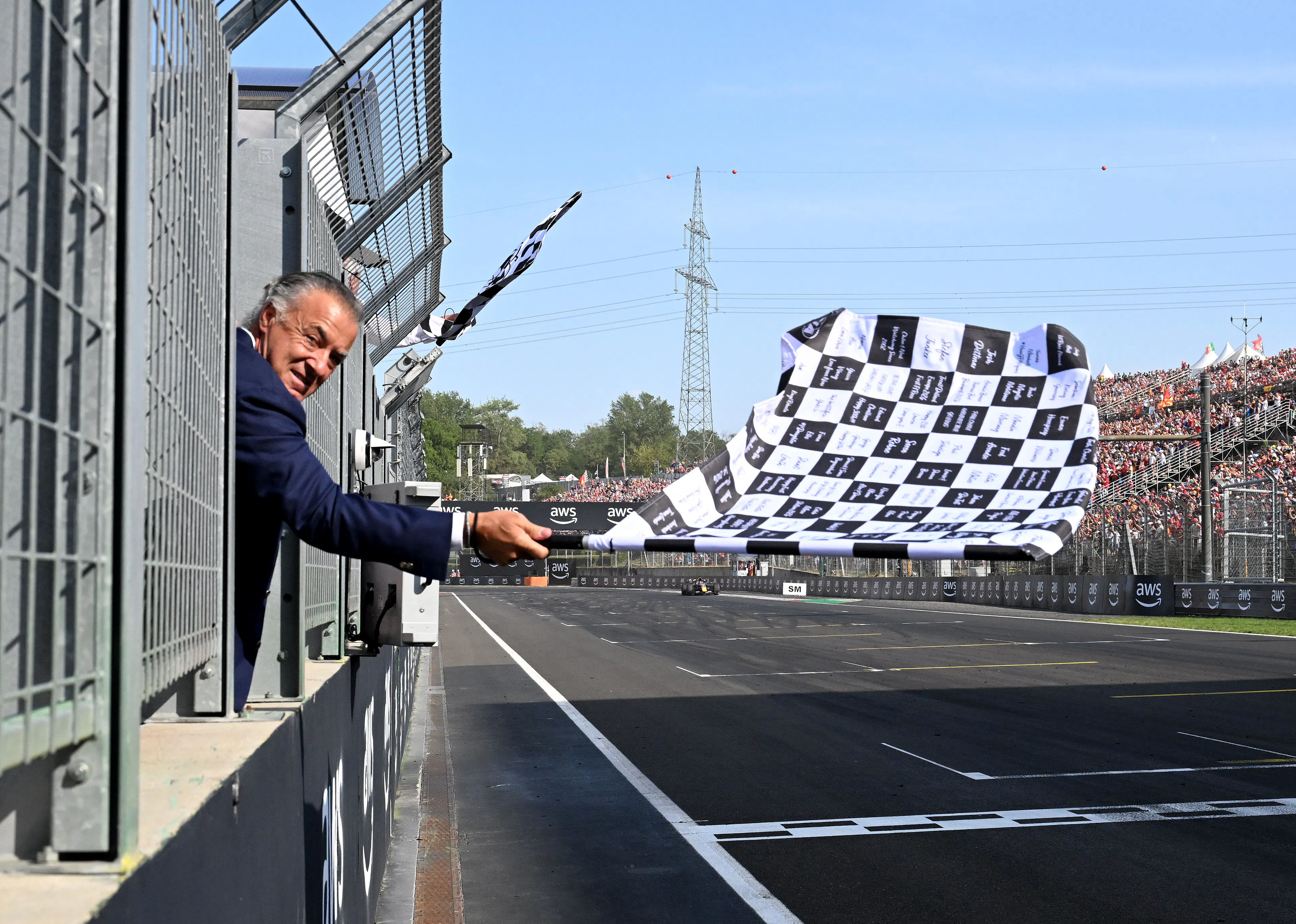 A man waving a checkered flag at the end of an F1 race