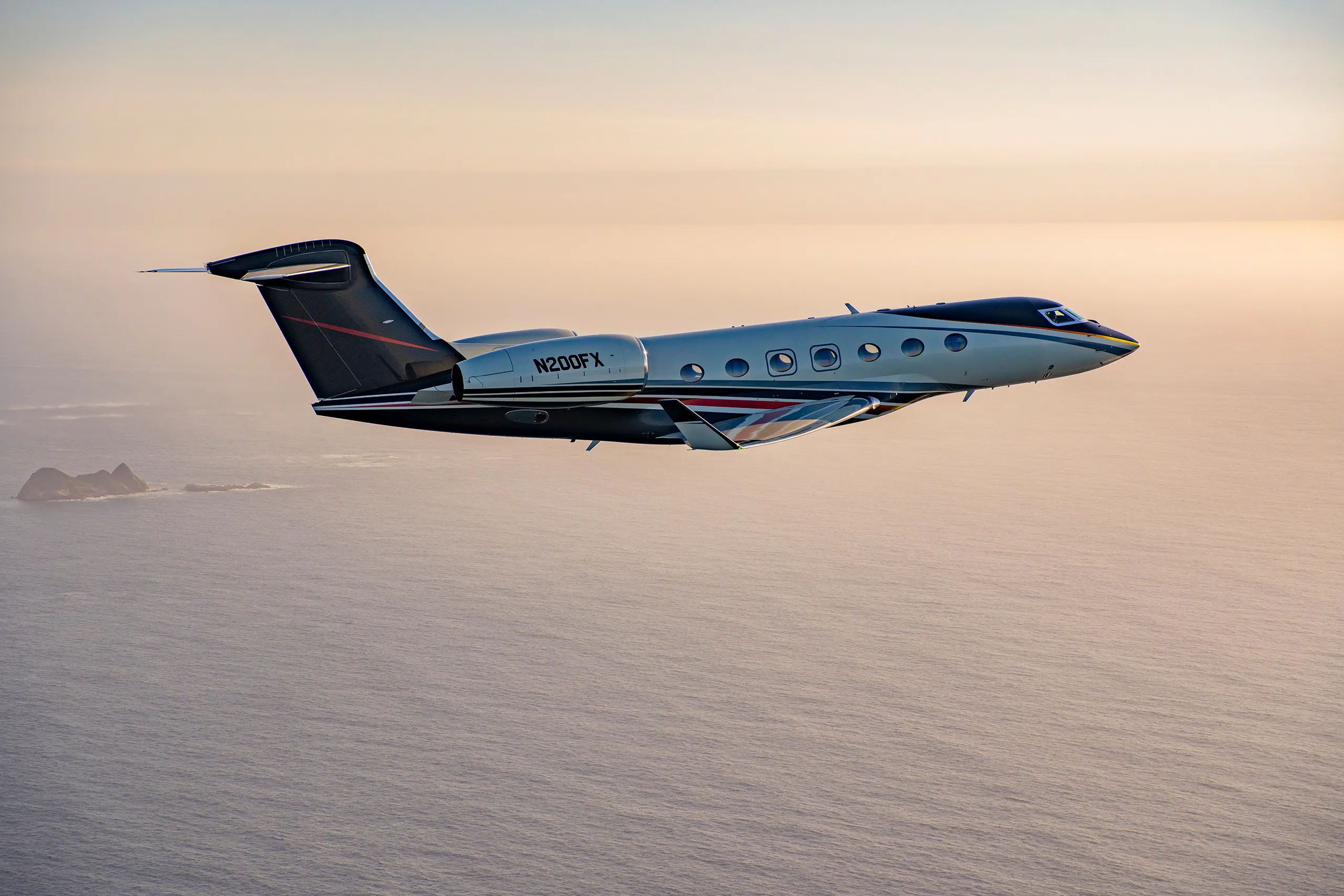 A G500 Gulfstream flying left to right in the evening