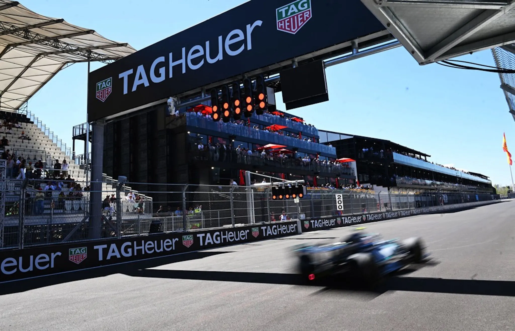 Action shot of an F1 car blurring through the finish line