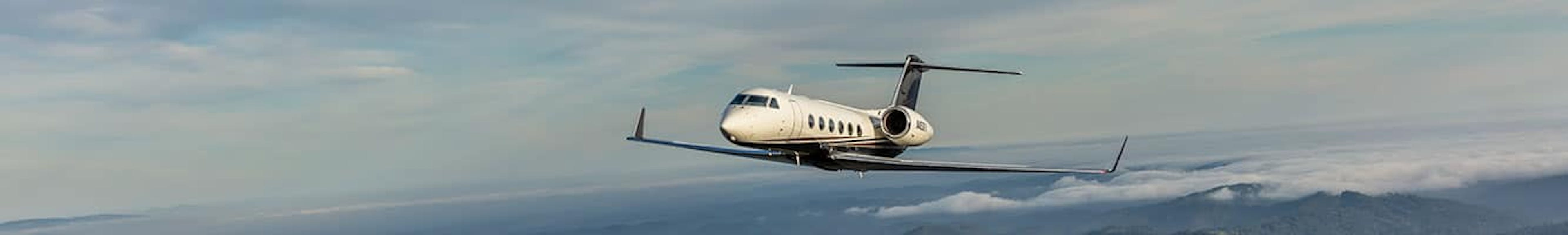 A long, rectangular image of a flexjet aircraft flying in the sky