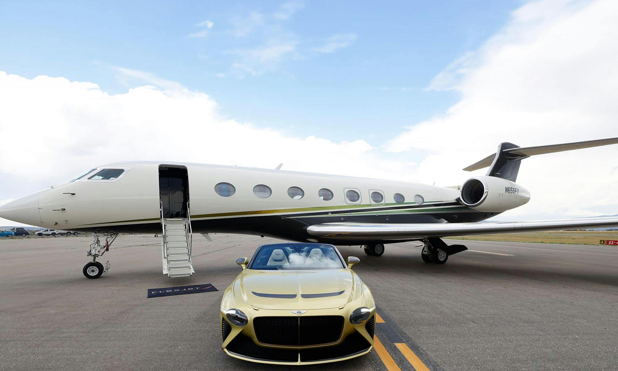 A golden Bentley sits outside a flexjet aircraft on the tarmac with its stairs down and flexjet mat at the base