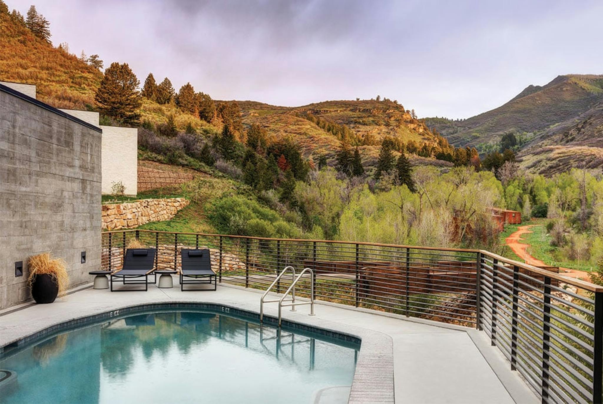 A pool on a balcony among hills and nature