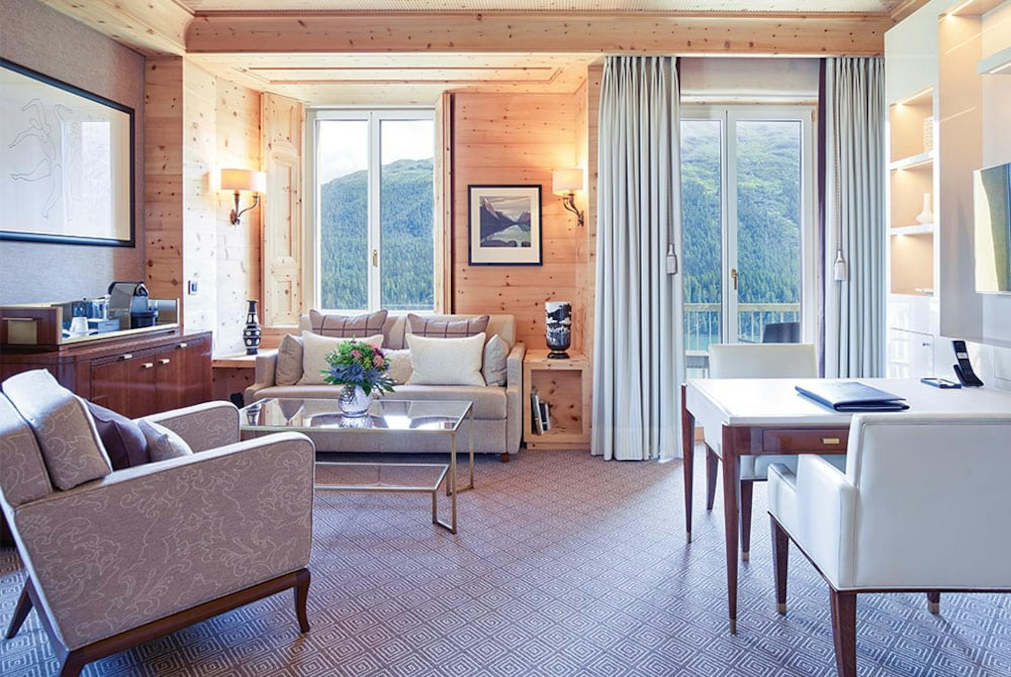 modern furnished hotel room with green mountains far in the background