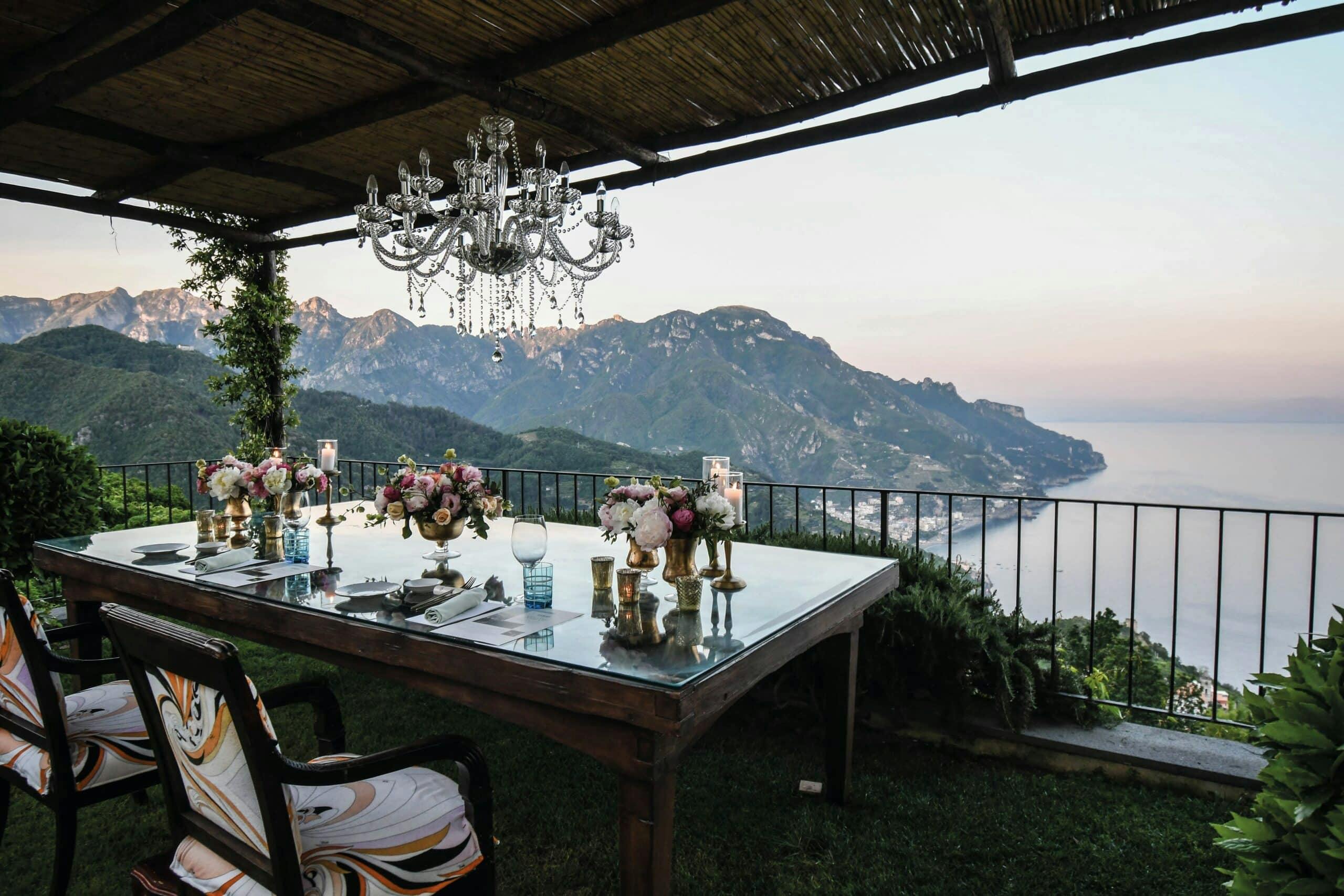 Dining table on a balcony overlooking a beautiful bay