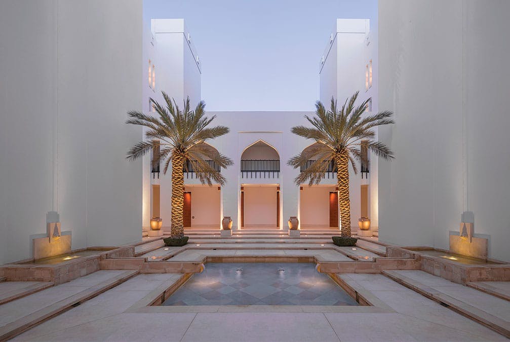 Chedi interior courtyard with palm trees and elegant pool