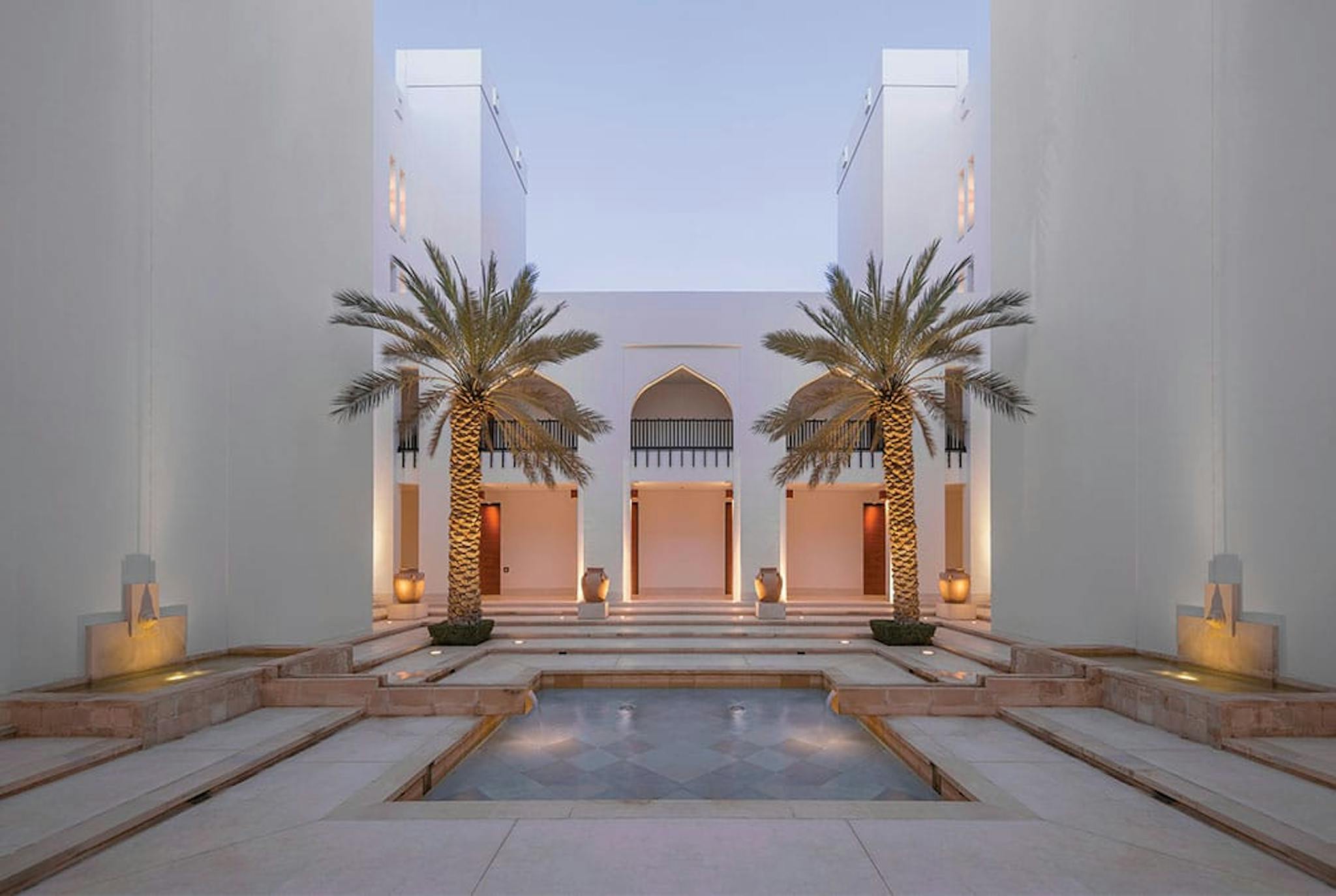 Chedi interior courtyard with palm trees and elegant pool
