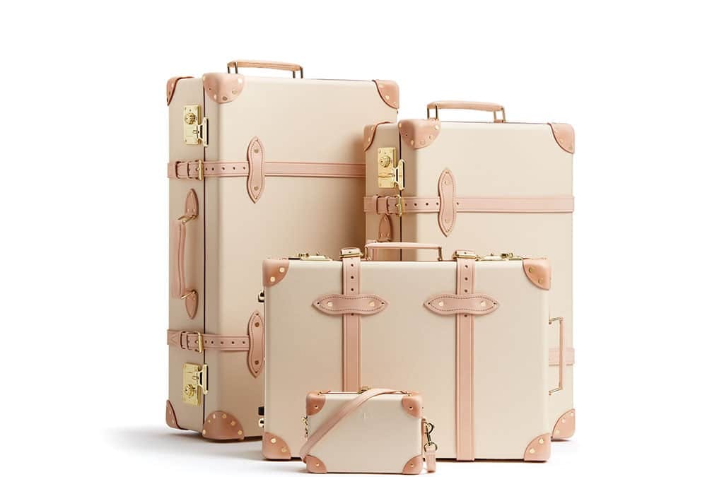 Light colored with gold accents on 4 different sized pieces of luggage