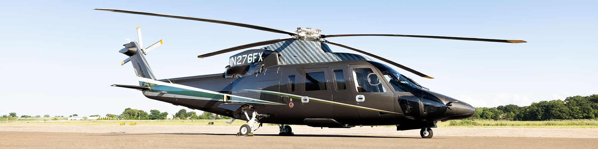 An S76 sits on an airfield