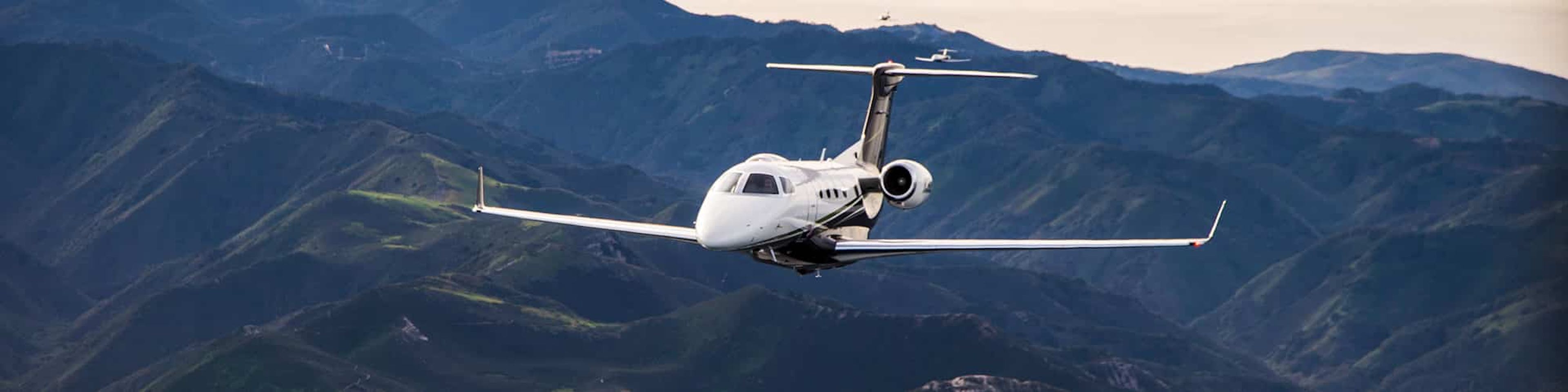A flexjet aircraft flies over mountains