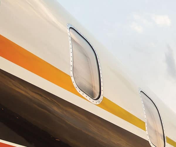 close up image of two windows and the custom paint job of a private jet