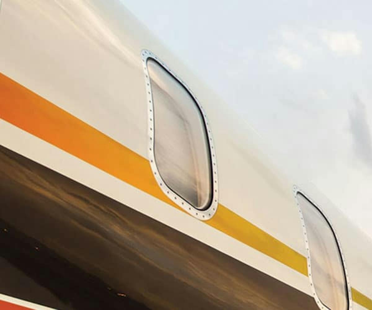 close up image of two windows and the custom paint job of a private jet