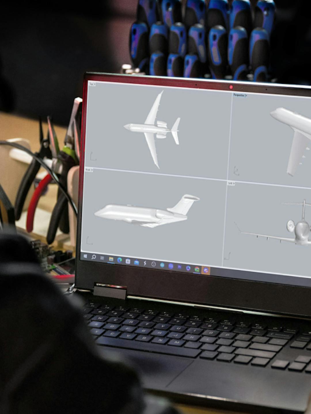 Over the shoulder of someone viewing a laptop screen with CGI aircraft images