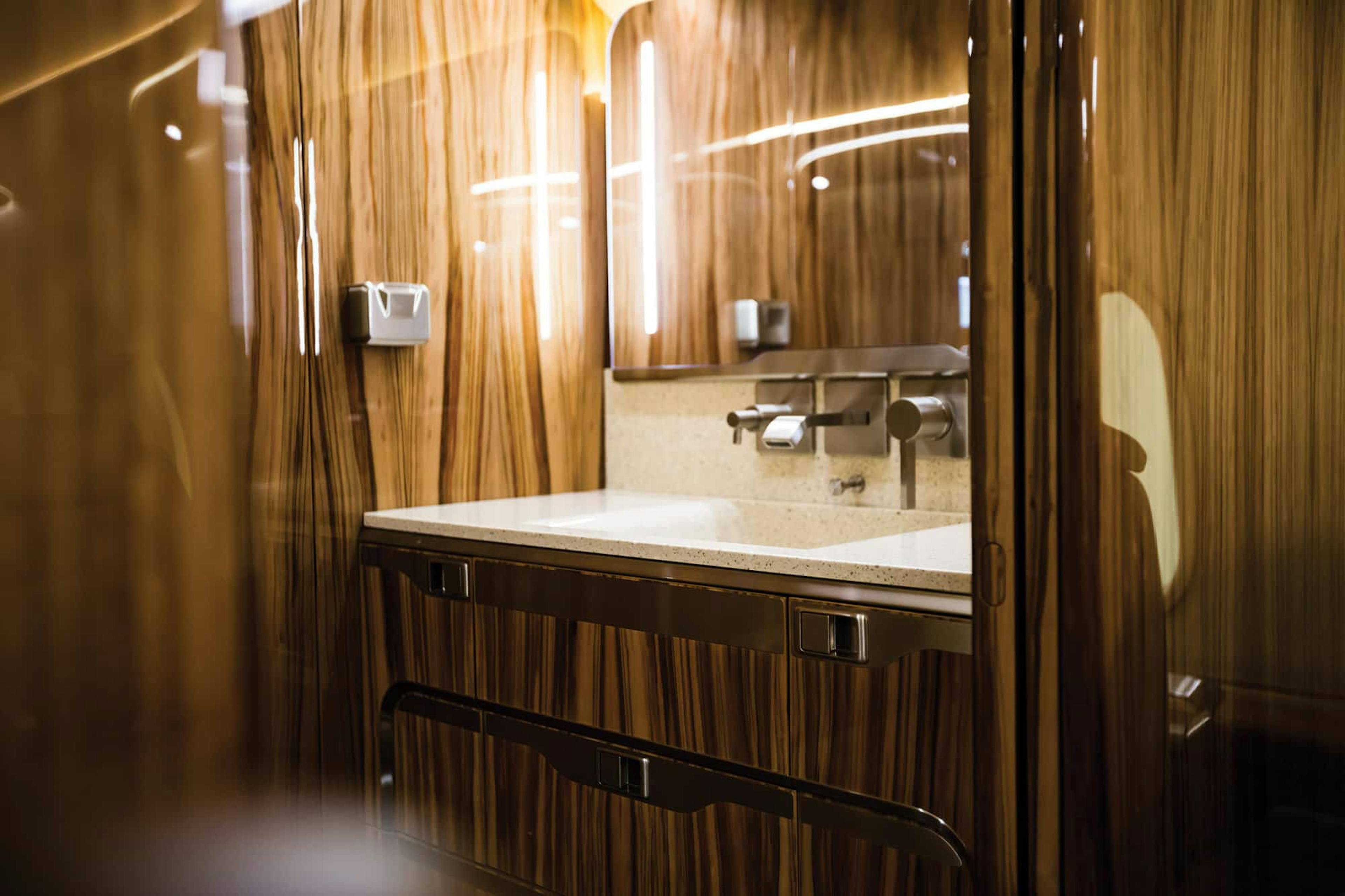 The shiny wood bathroom features and sink