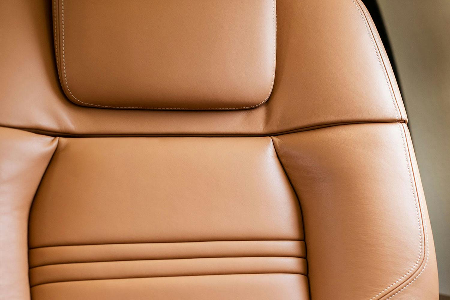 Inside the Praetor 500, focused on the caramel colored leather seatback