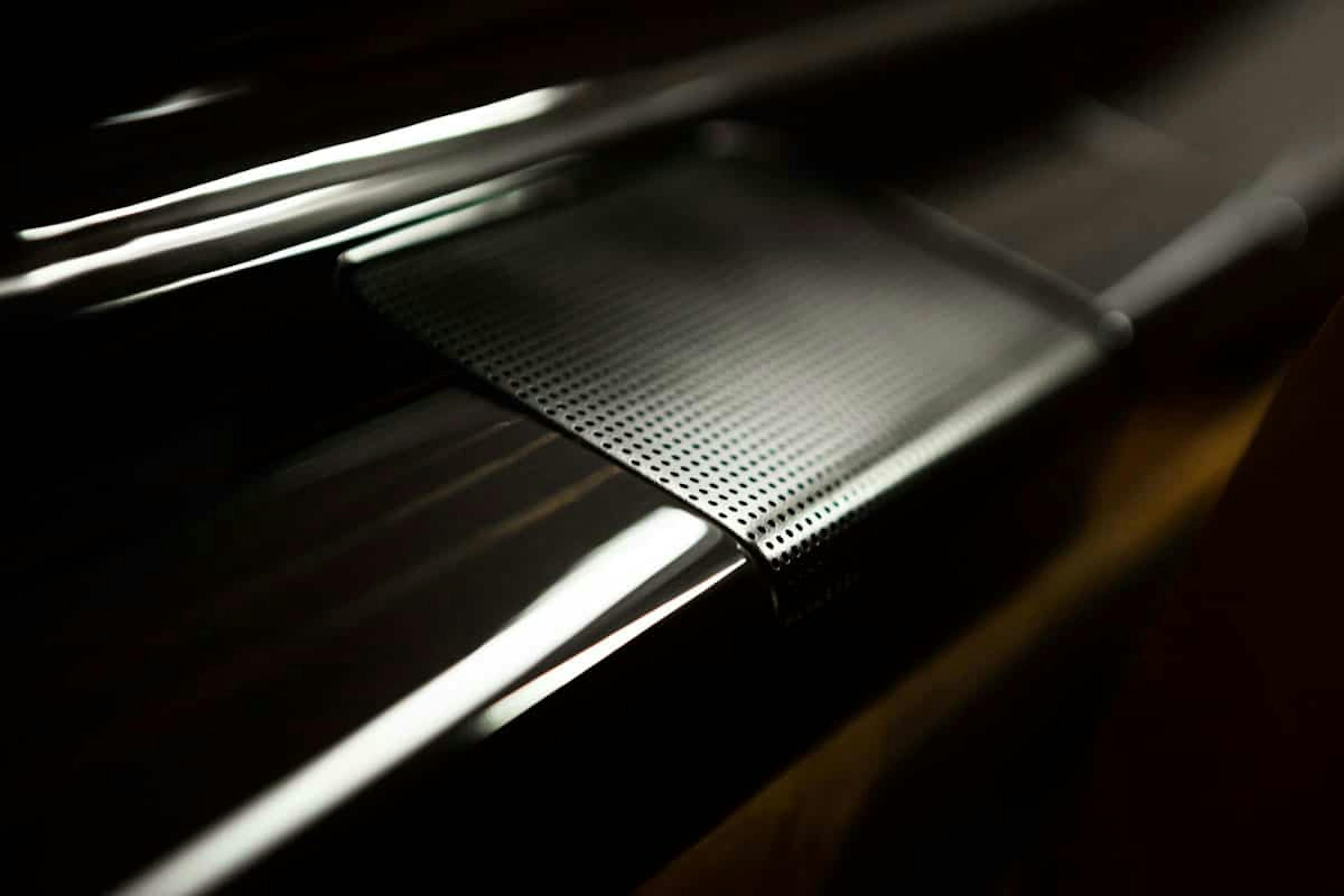 Quality interior of the Phenom 300, focused on the shiny custom side table with dark wood grain