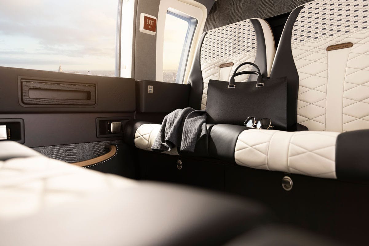 A pull back view of the custom seating and cabin walls and windows of the Bacalar S 76 helicopter interior