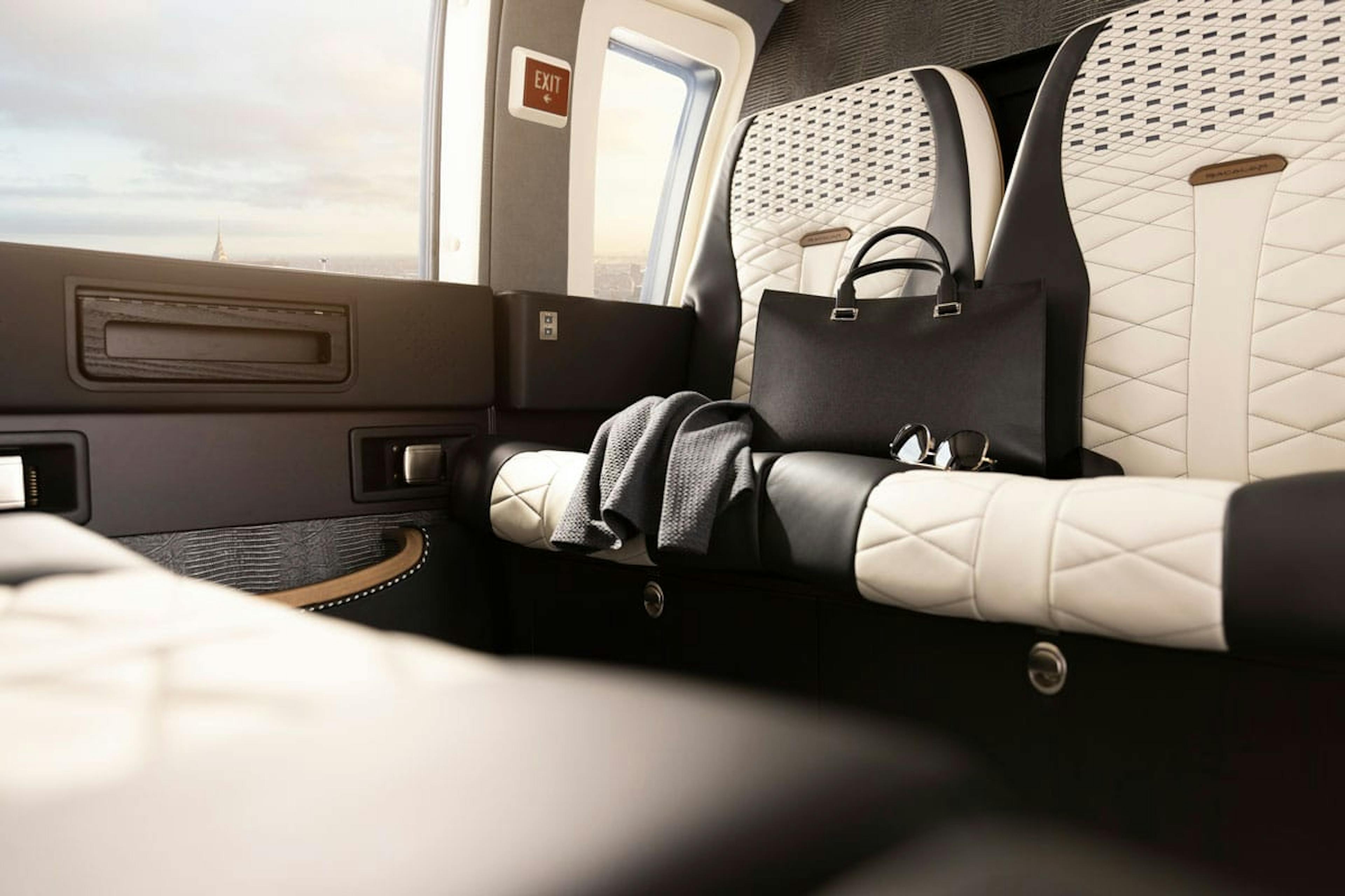 A pull back view of the custom seating and cabin walls and windows of the Bacalar S 76 helicopter interior