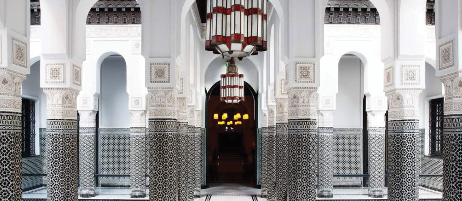 opulent pillars and chandelier with shades of white and grey make up a courtyard