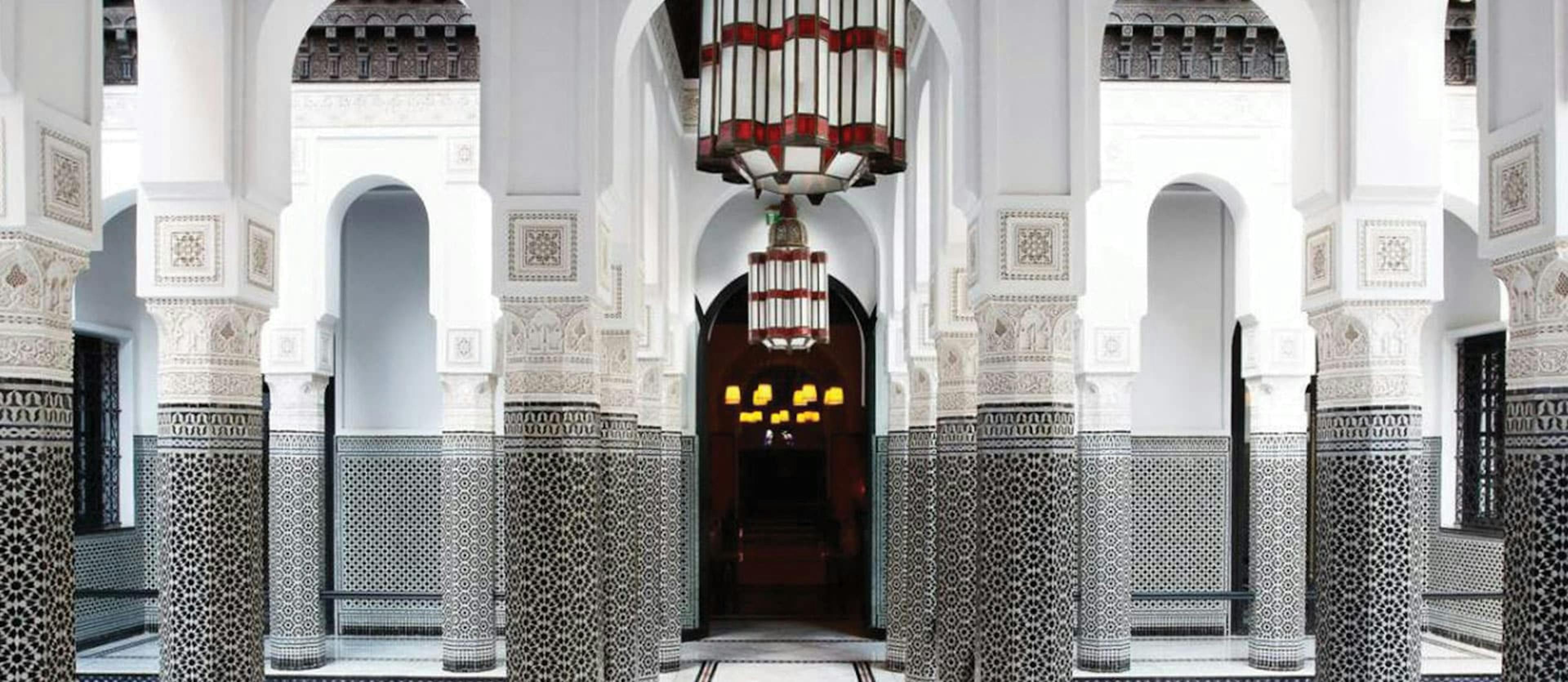 opulent pillars and chandelier with shades of white and grey make up a courtyard