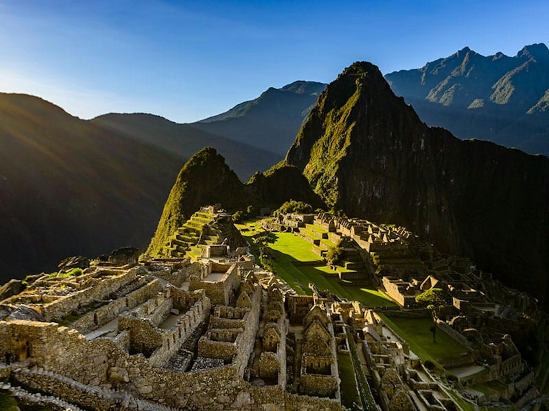 the hills of macchu pichu among the mountains illuminated by early sunlight