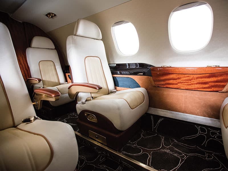 section on a private aircraft with custom seats and carpeting