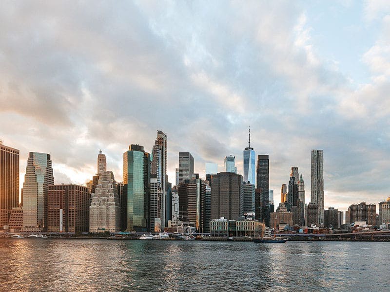 the view of a city skyline from a body of water