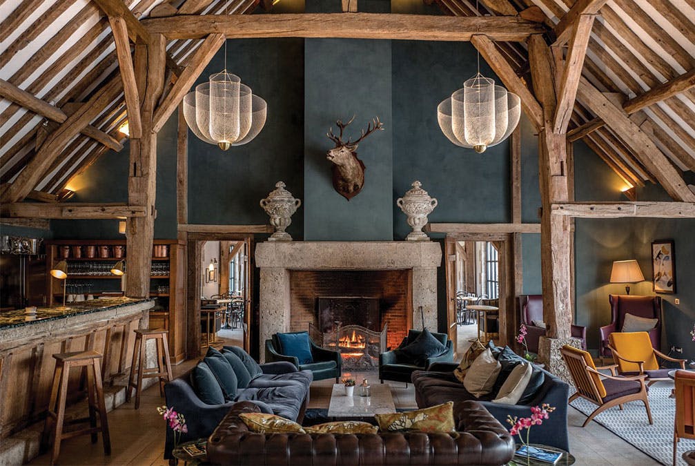 Rustic hotel lobby with things like mounted deer head and wood beams
