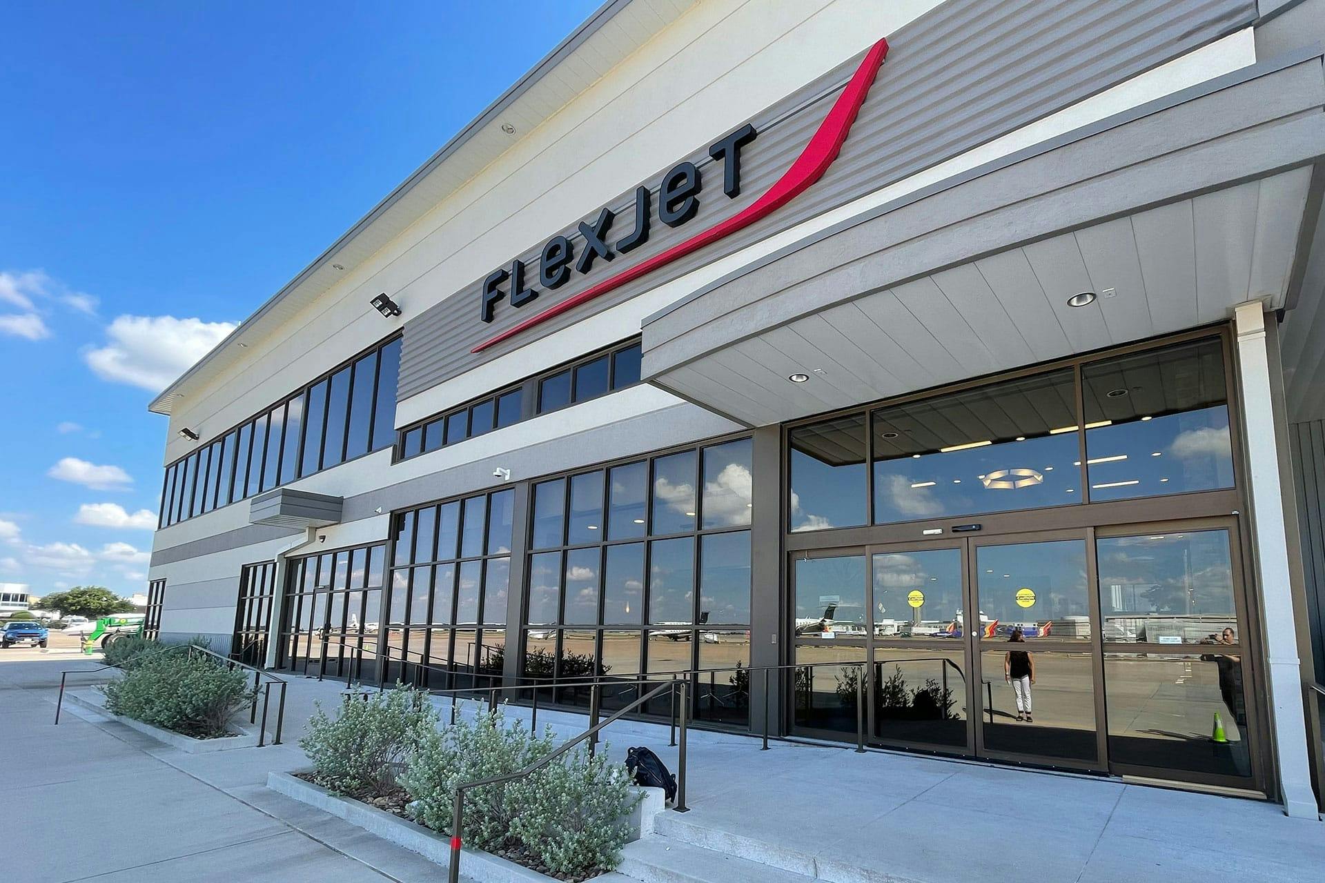 Outside the Dallas Private Terminal with a flexjet logo sign above the entrance