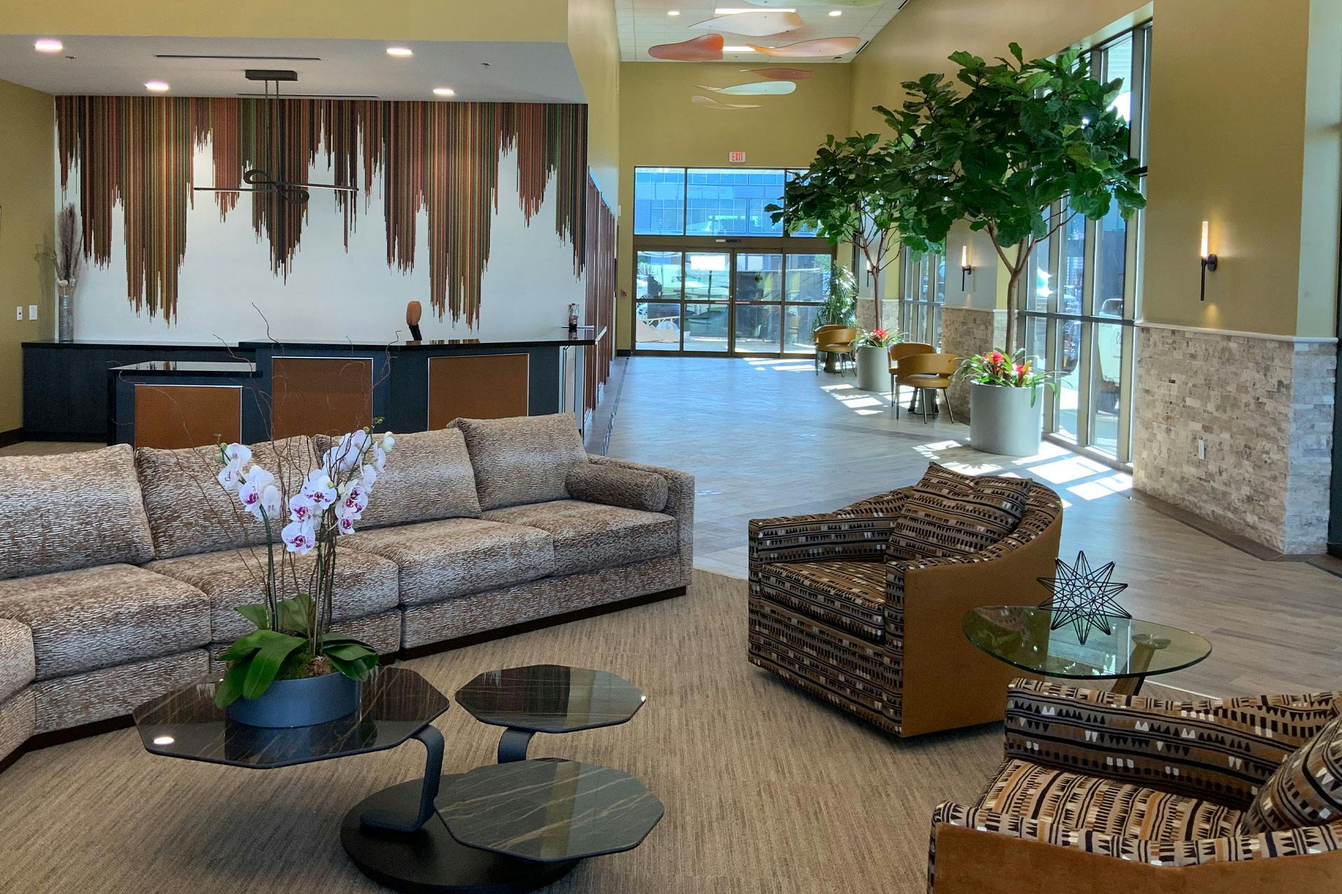 Inside the Dallas Private Terminal with plants and shades of brown furniture