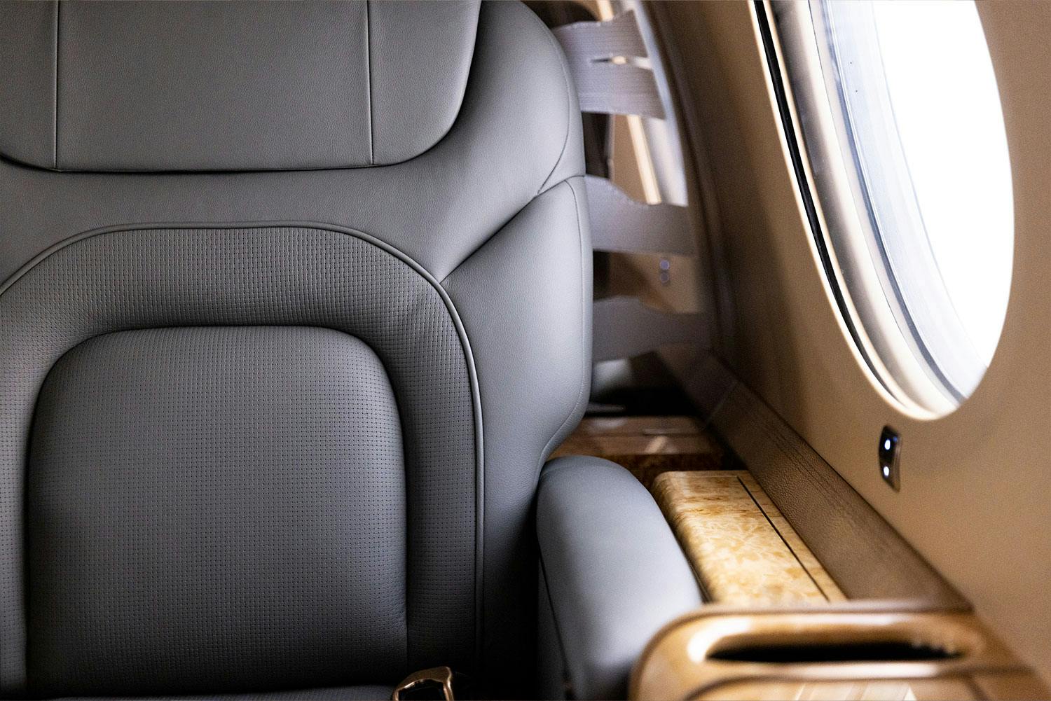 Luxury interior Capri inside a private jet focused on the intricate stitching and seems of the leather seat