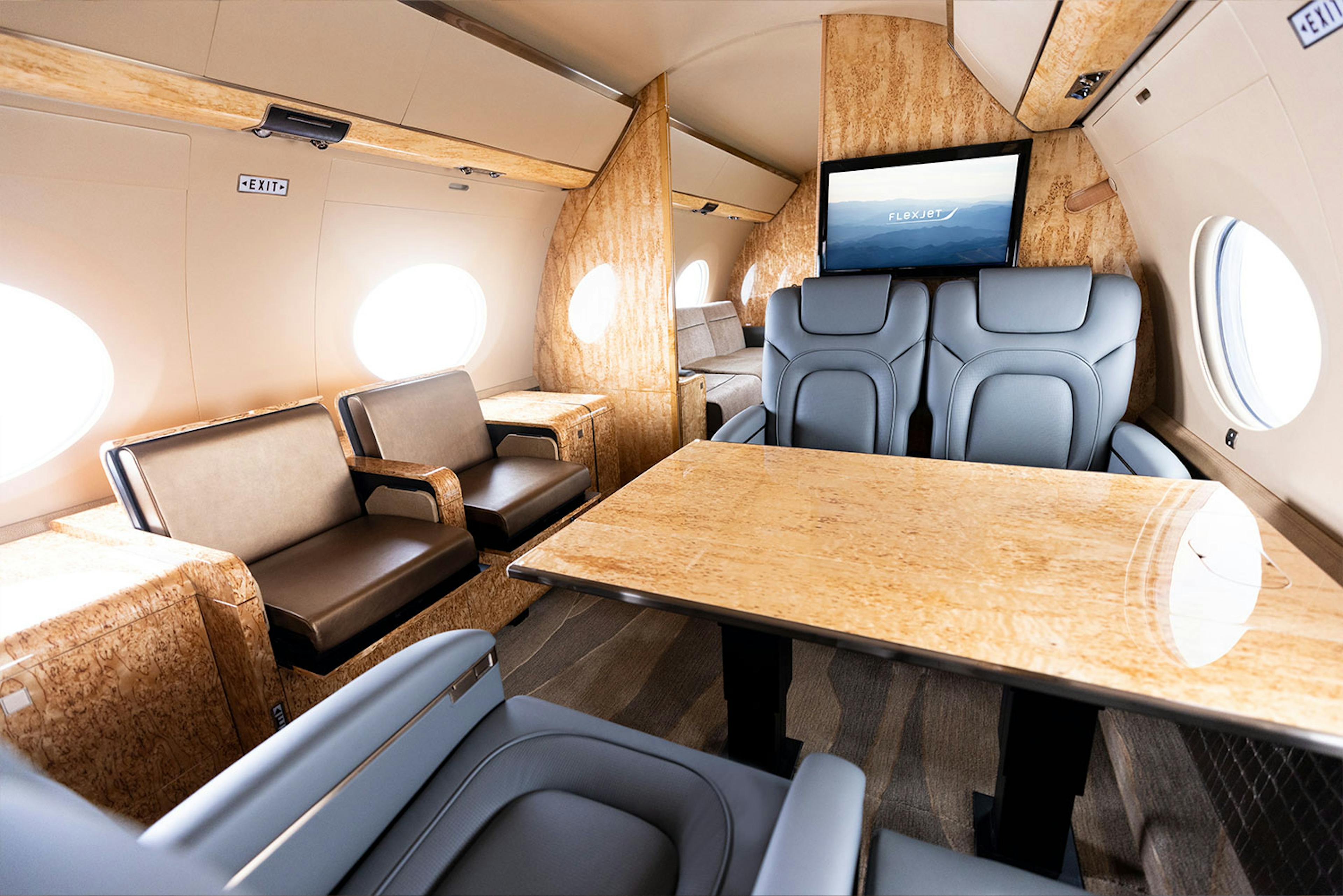 Luxury interior Capri inside a private jet focused on the table and chair configuration