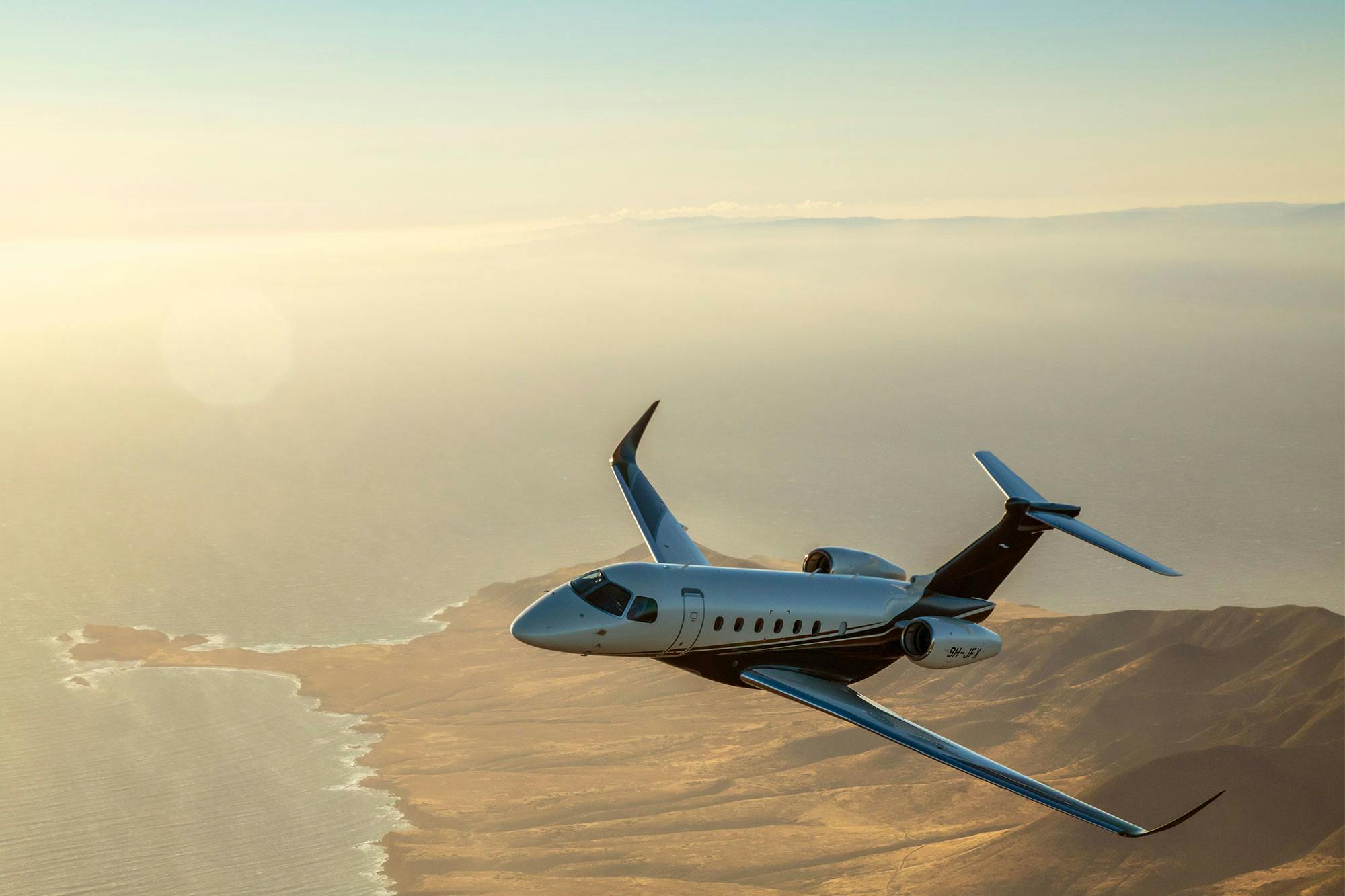 EU version of the jet card hero image featuring a flexjet aircraft over a ridge of land at the reach of water