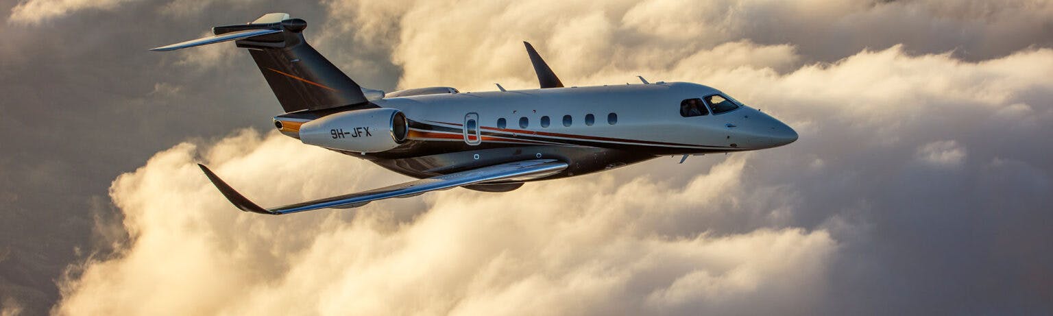 Jet card image spacer feature a flexjet aircraft flying above the clouds