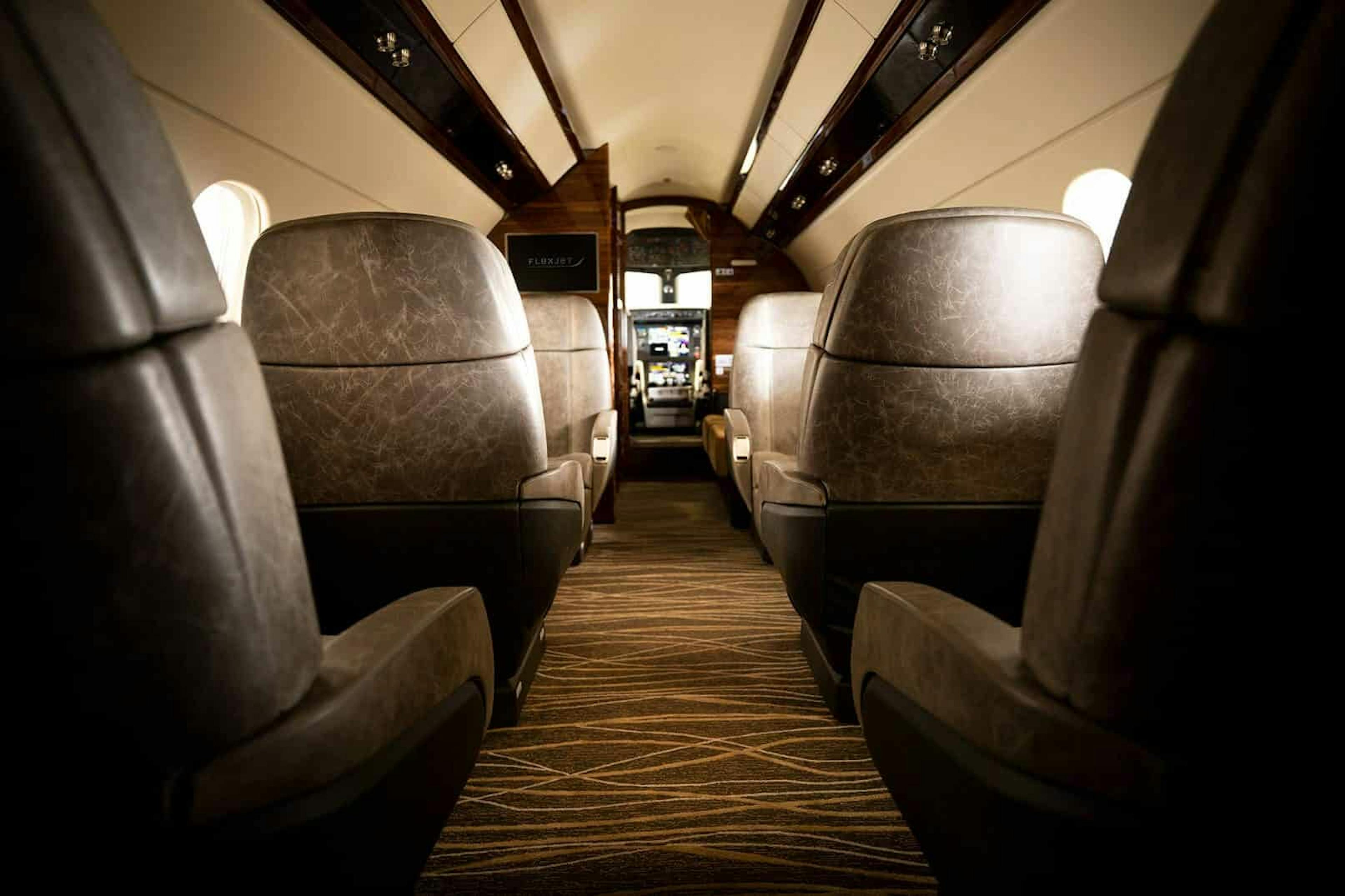 Chestnut, Flexjet, private jet, Legacy 450, jet interior, midsize, super midsize, mid cabin, Embraer, LXi Cabin Collection, seating, seat view, leather seating