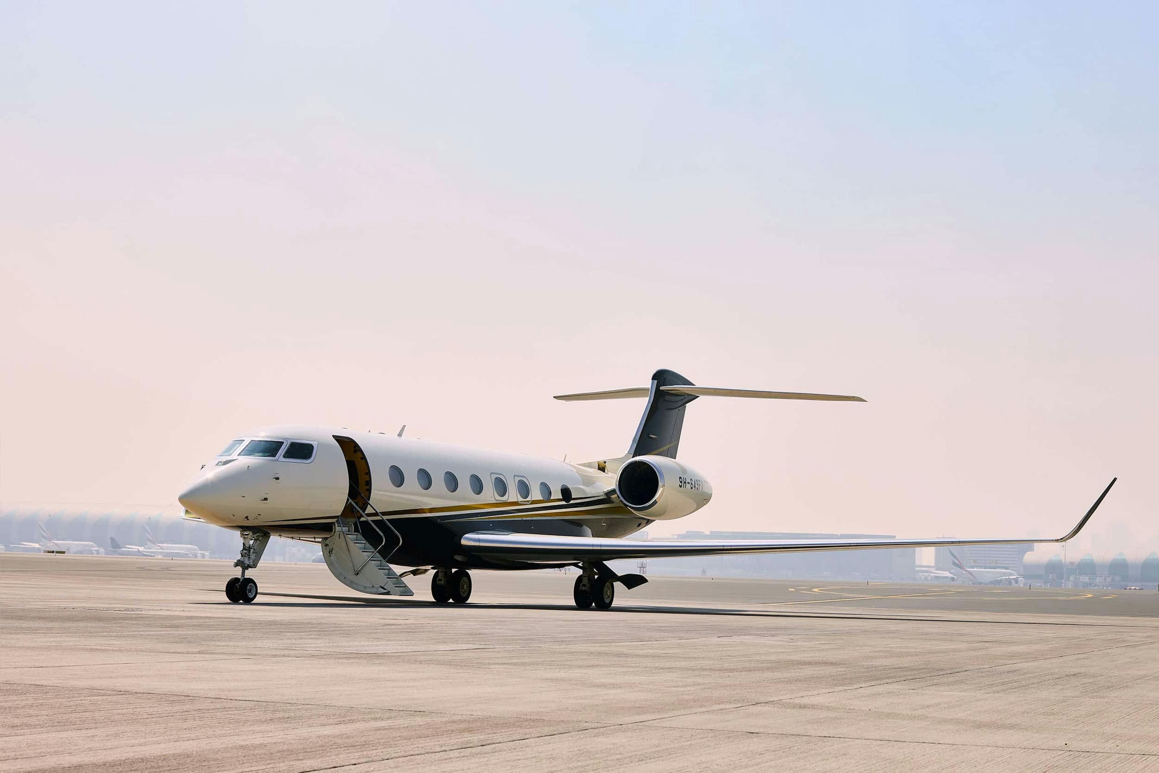 An EU-based flexjet aircraft sits on the tarmac with light blue and pink skies behind