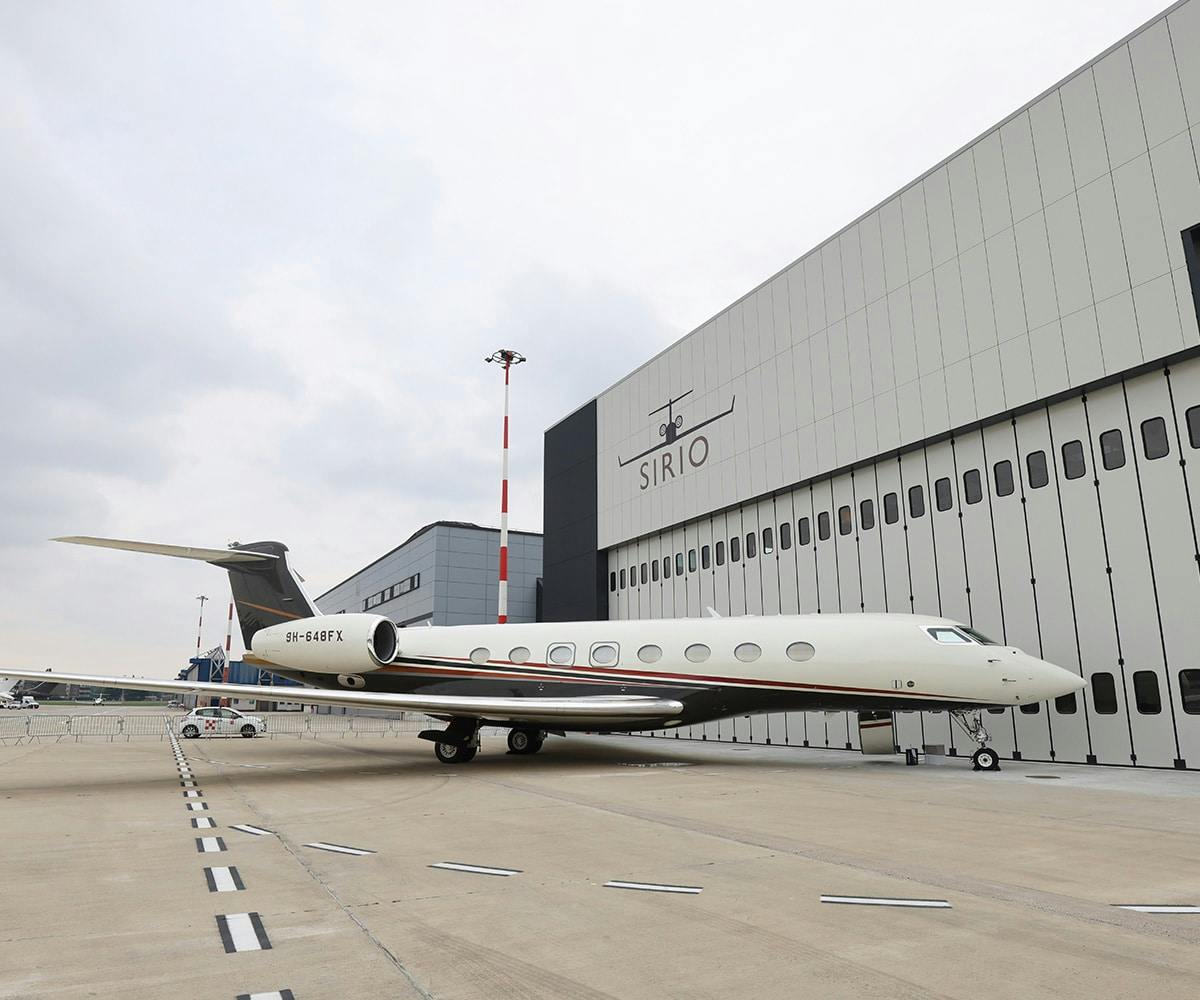A flexjet aircraft outside a Sirio hanger