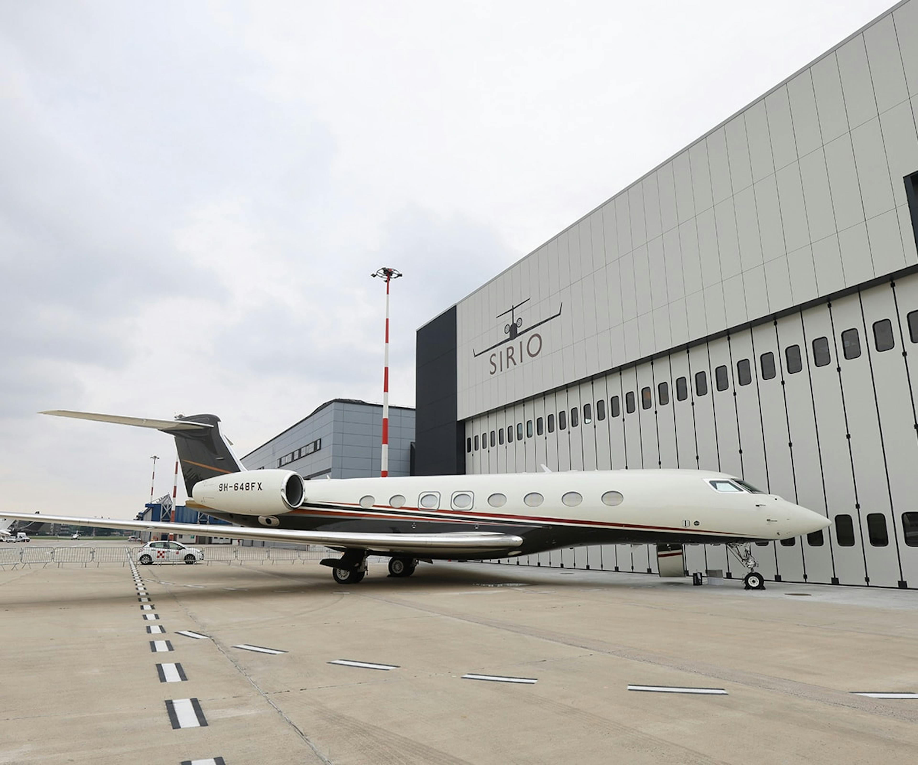 A flexjet aircraft outside a Sirio hanger