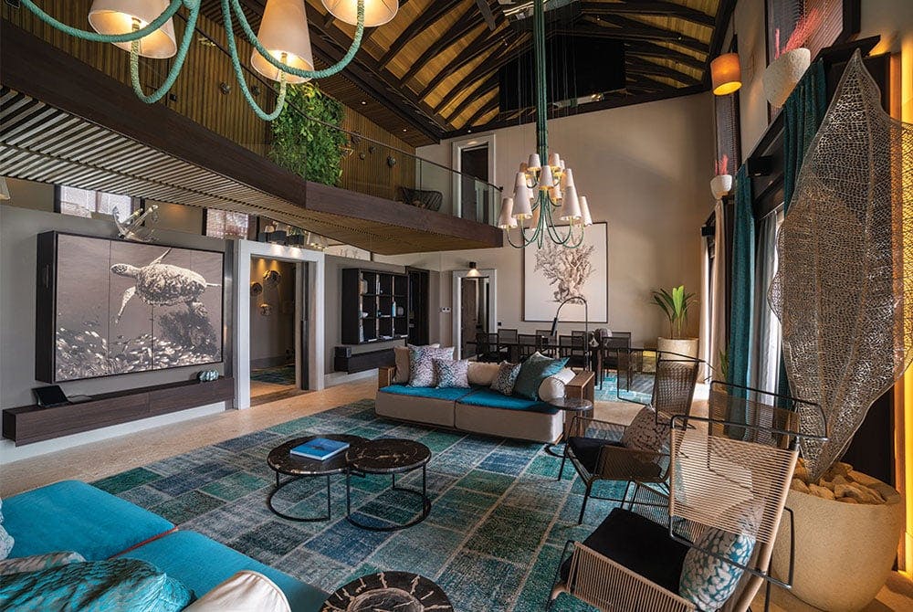 Velaa interior of the hotel with turquoise and light colors on the rug and sofa