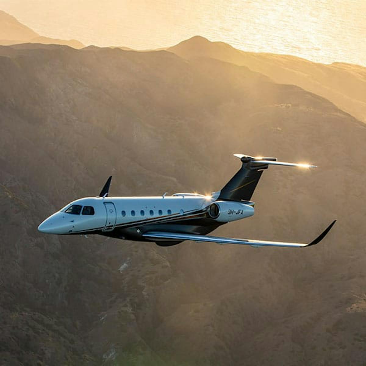 Praetor 600 flying over mountains among yellow skies