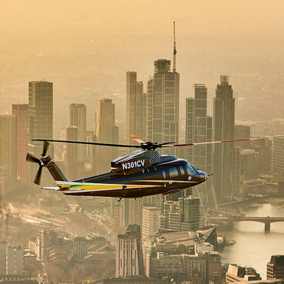 An s-76 flies over the city with a yellow tint to the sky