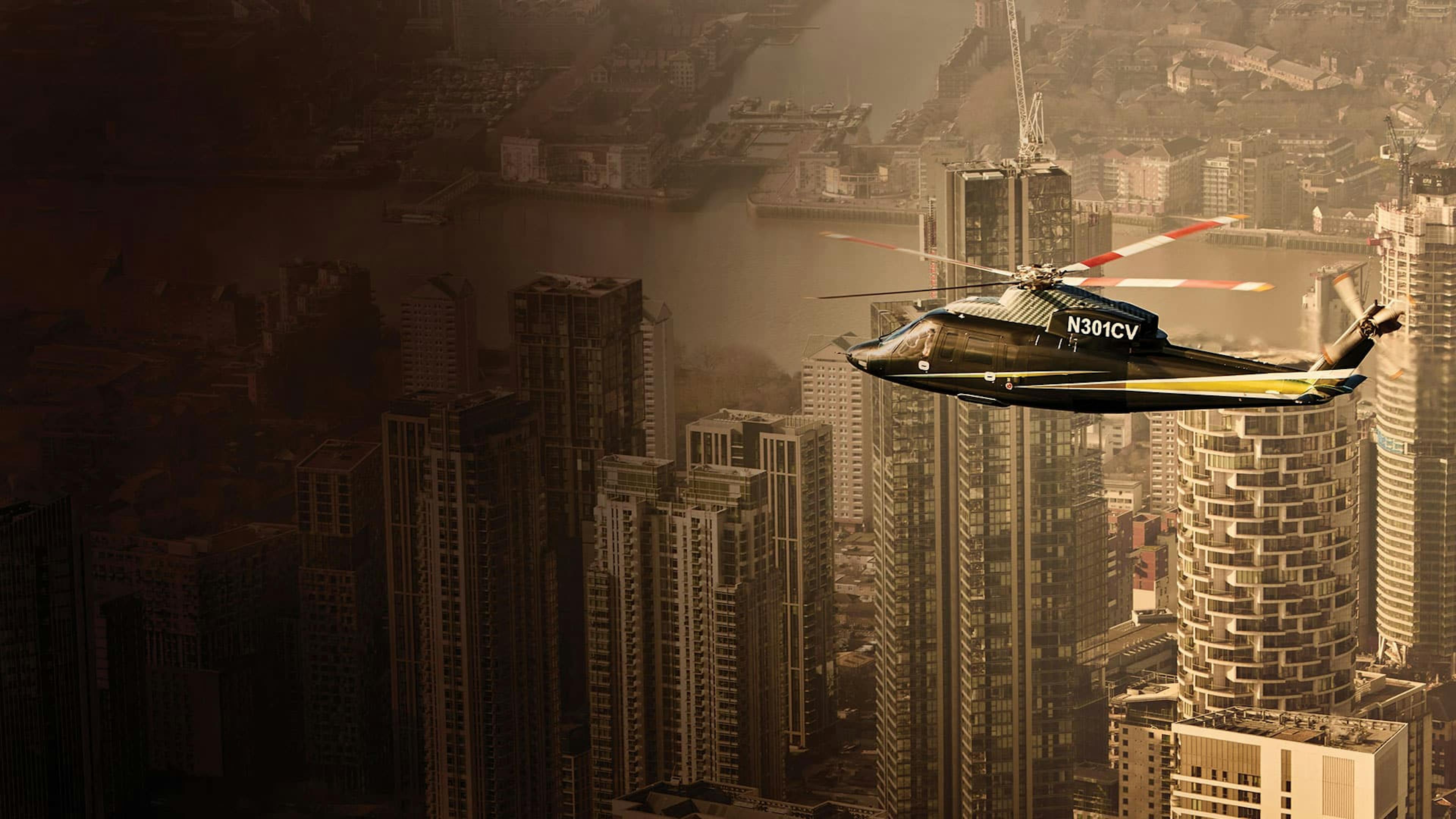 An S76 flies above tall buildings in a city with a yellow tint and dark silhouette on the left side of the photo