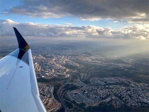 view from the aircraft seeing the wing and above the city of tel aviv