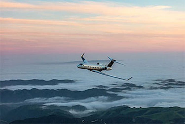 large flexjet aircraft soaring above the mountains