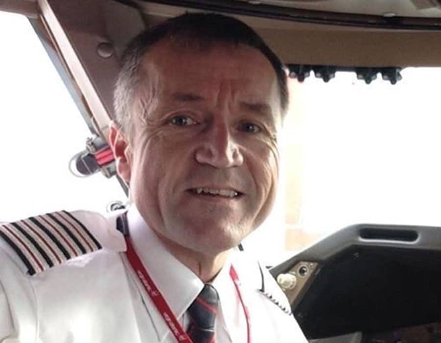 Clive Richardson in the cockpit wearing the pilots uniform